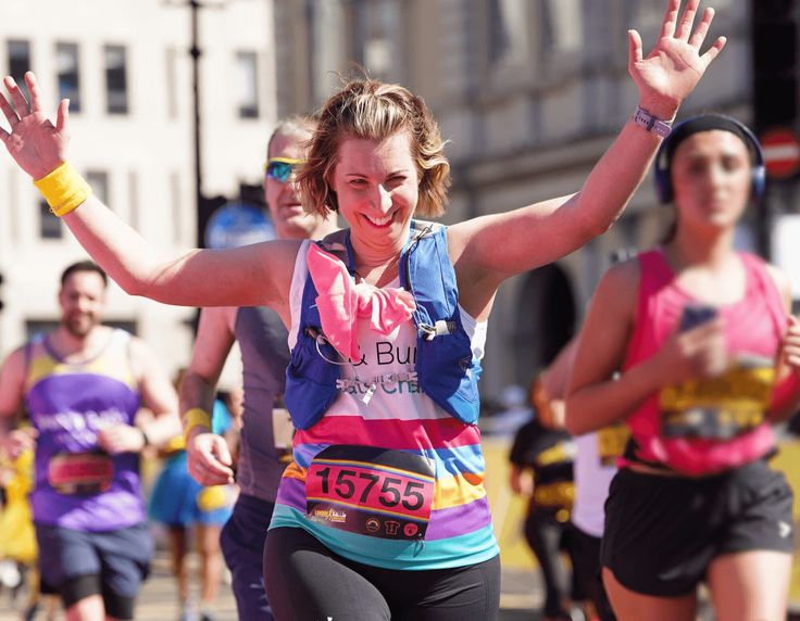 A woman smiling and running