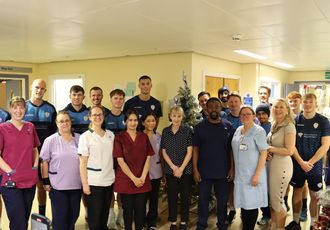 Cricket club members with NHS staff